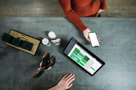 Top down desk with tablet and phone